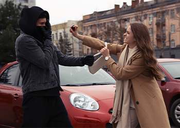 Woman using pepper spray for defense against thief