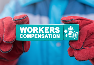 Person holding paper block with words Worker Compensation