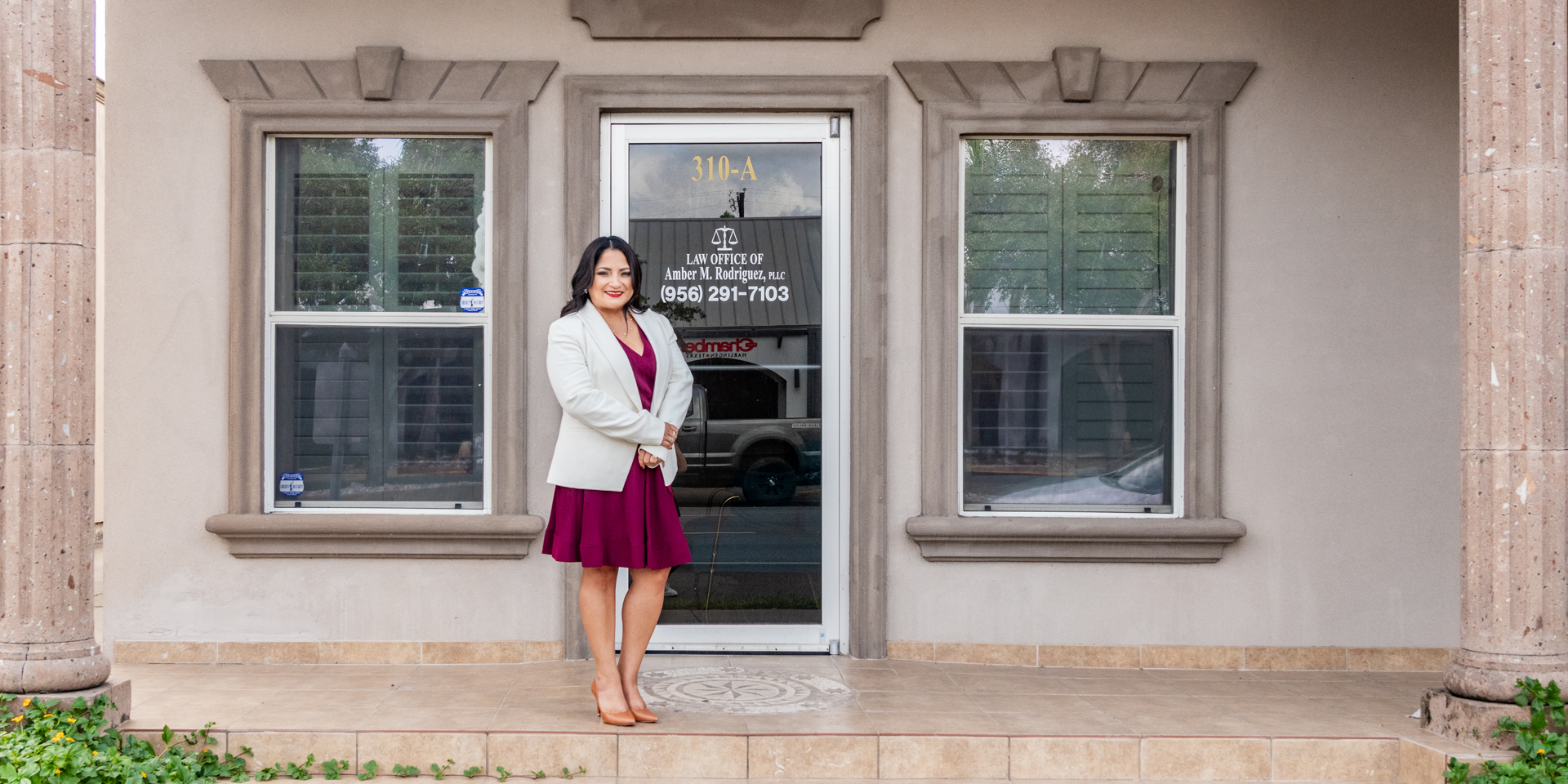Amber Rodriguez in front of her law office building