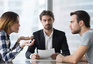 Spouses split up disputing about divorce settlement in lawyers office