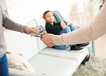 Man giving alimony to his ex-wife at home