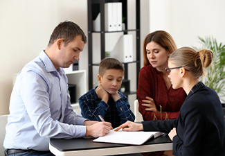 Divorced parents with their son visiting lawyer
