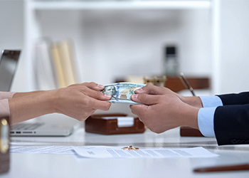 Divorced couples pulling money, concept of dividing marital property