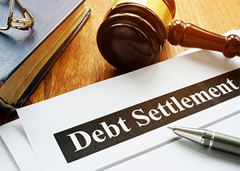 Debt Settlement documents and gavel in table