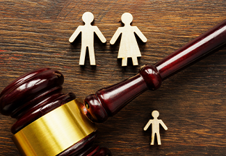 Family figures and gavel on table