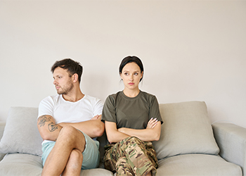 Military couple sitting in closed poses after argument