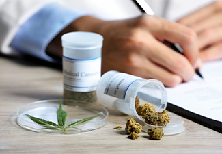 Doctor writing on prescription blank and bottle with medical cannabis