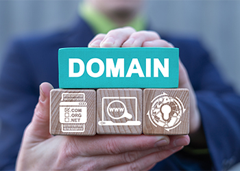 Man holds blocks with word Domain and related icons