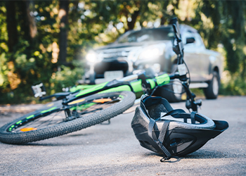 Bicycle with helmet on road after car accident