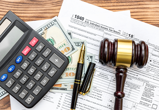 Gavel with calculator and money on tax form