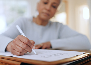 Old women signing will document