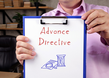 Man holding notepad with word Advanced Directive
