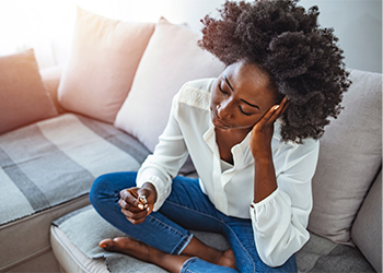 Women considering divorce holding wedding ring in hand