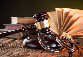 Wooden gavel and books on wooden table