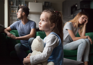 Daughter holding toy dreaming that family conflicts would stop