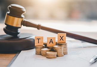 Wooden blocks word " TAX" on coin stack