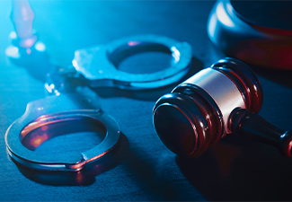 Crime and violence concept with handcuffs and gavel