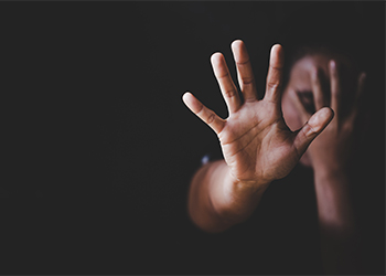 Women raising hand signaling to stop domestic violence