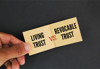 Two soft brown papers with the words living trust vs revocable trust