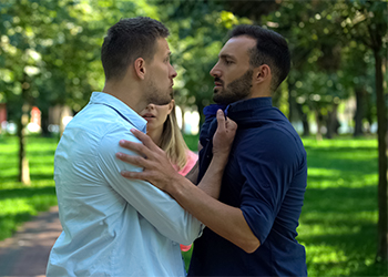 Aggressive man threating another man outdoors