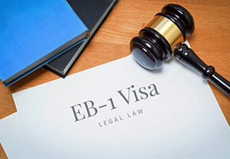 Desk with EB-1 visa document and judges gavel in a lawyer's office