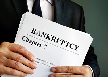 Man with Bankruptcy Chapter 7 documents in hand