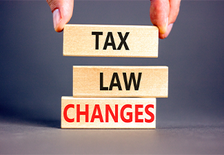 Words Tax law changes on wooden blocks on a beautiful grey table