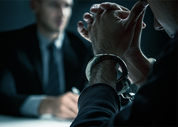 Man with handcuffs in interrogation room