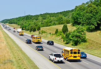 School Buses And Other Traffic On Interstate Highway
