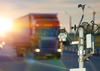 Surveillance camera and passing truck on road