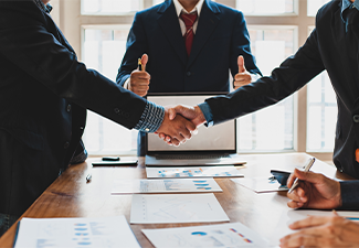 Business people shake hands while negotiating a business deal