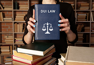 Lawyer holds DUI LAW book