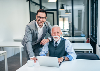 Smiling father son duo in office