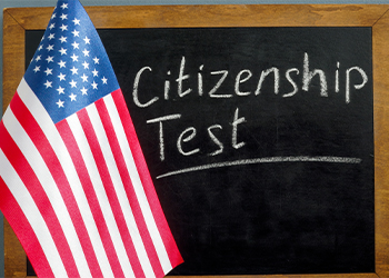 USA flag and inscription citizenship test on the blackboard