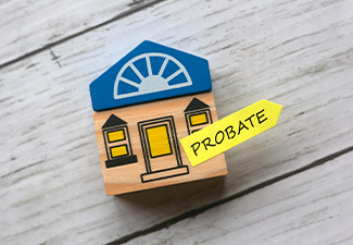 Toy wooden house and sticky note written with Probate 