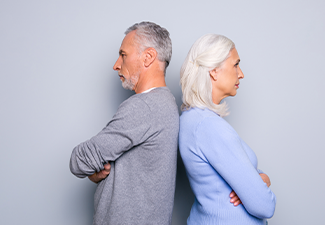 Angry old couple standing