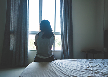 Women sitting alone in dark room