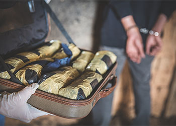 Police arrest drug trafficker with handcuffs