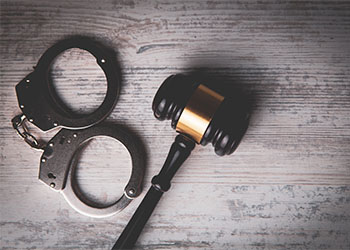 Handcuff and Gavel on table