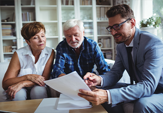 Senior couple planning their estate with financial advisor