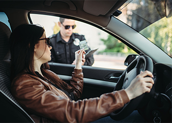 Women showing her driving license to traffic