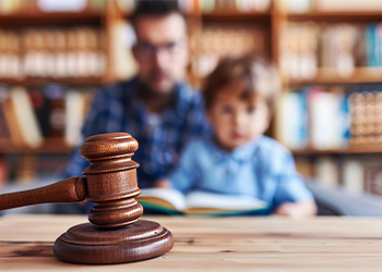 Gavel with child and father in background