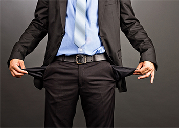 Businessman showing his empty pockets