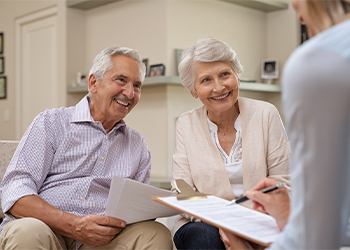 Old couple consulting with attorney regarding estate planning