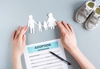 Family paper figures in adopting concept on gray background