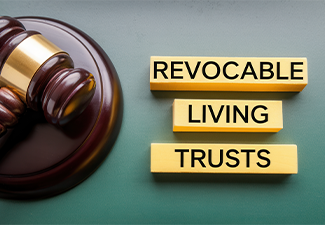 Gavel alongside revocable living trusts text on blocks