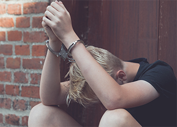 Teenage boy in handcuffs