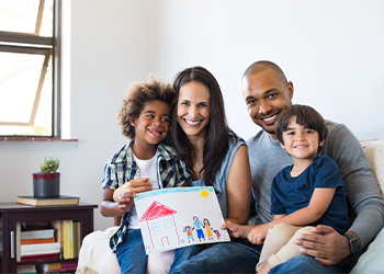 Multiethnic family sitting on sofa in home