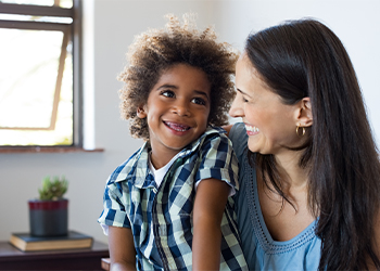 Women and her adopted child laughing