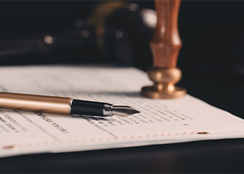 Pen on will document with notary stamp and gavel